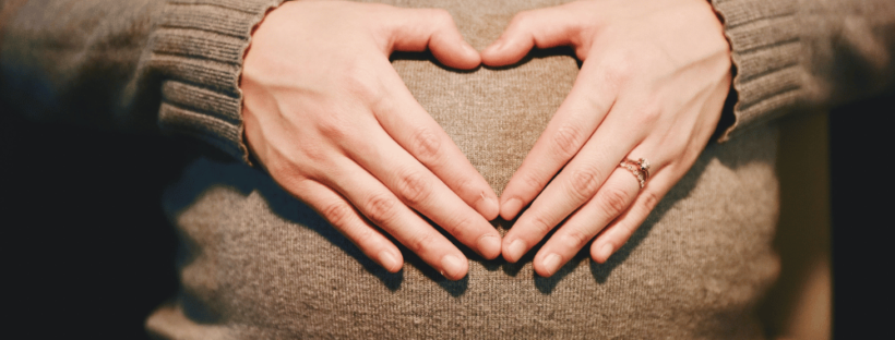 Mom-to-be heart hands