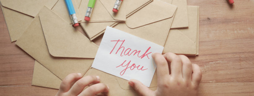 Child hands thank you note