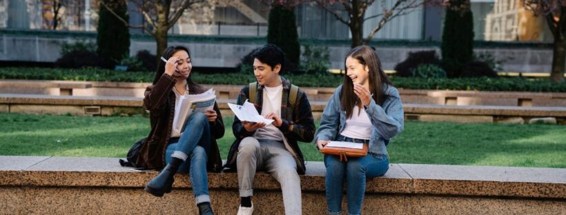 three college students sitting talking