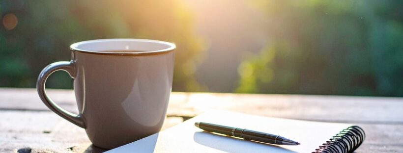 Coffee cup and notebook